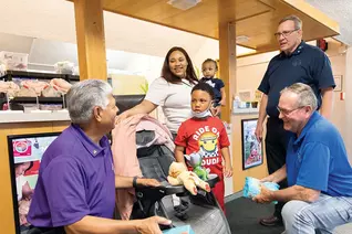 Illinois Knights speak with a mother and her children