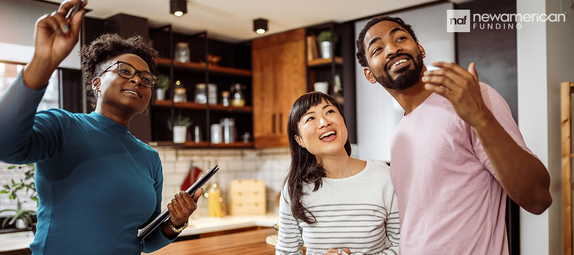 multi-cultural couple viewing a home shown by a black real estate agent