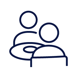 Icon of two people sitting across a table from each other 