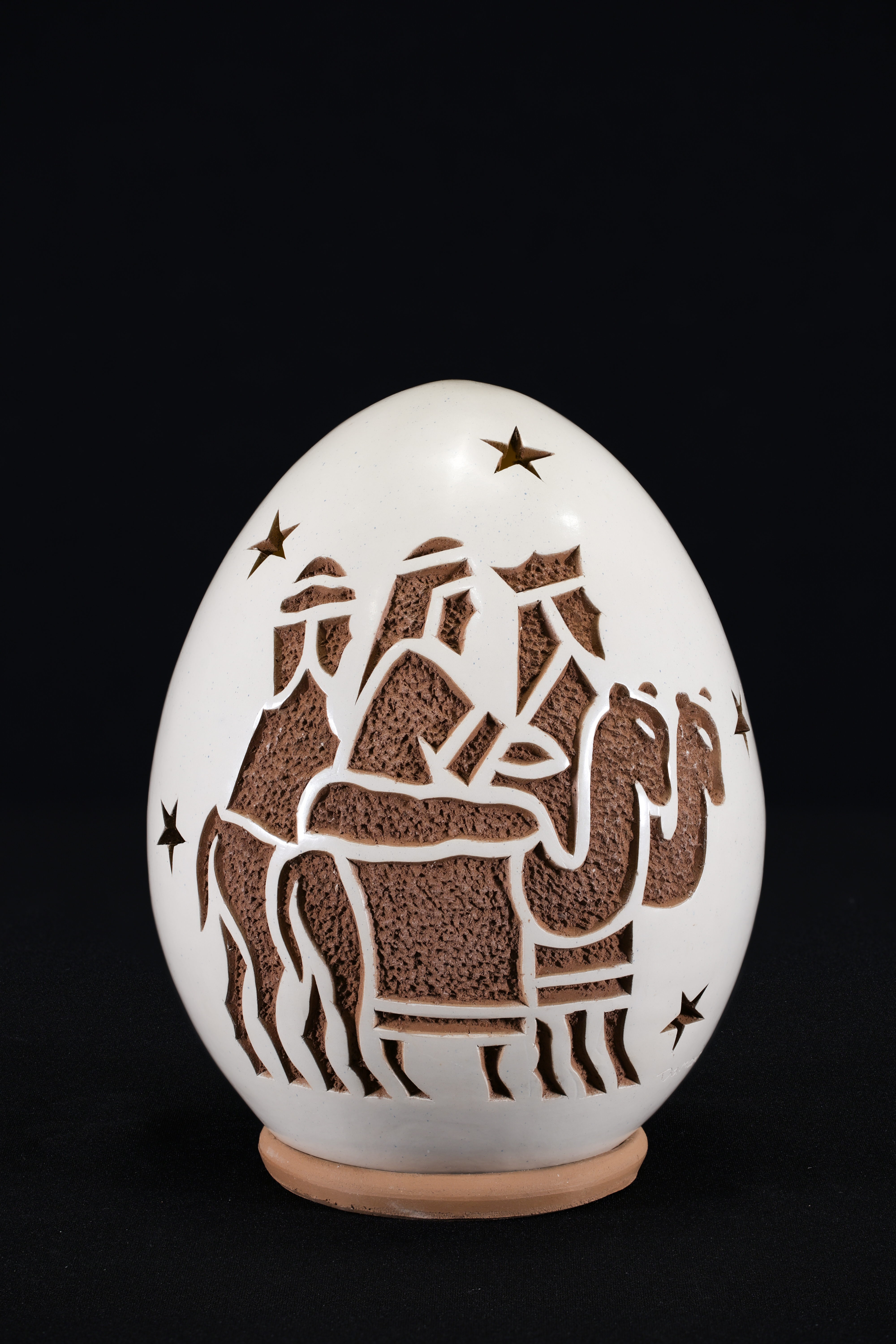 Crèche made in 2021 from Nicaragua. Painted clay egg decorated with 3 Magi, 2 camels, and stars.