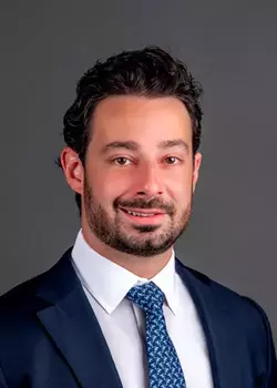 Headshot of Nicholas Gentile, Interim President & Chief Investment Officer, wearing a blue suit and tie
