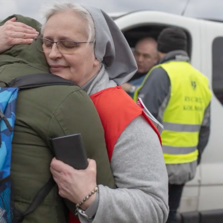 A Catholic nun embraces a parishioner in Ukraine.