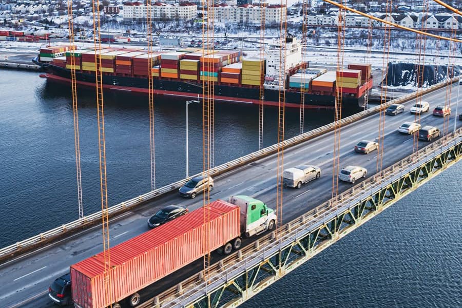 optimized-operations-chapter1-900x600.jpg Truck crossing a bridge to a port