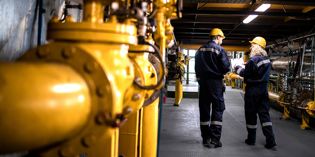 Two workers in an oil refinery plant
