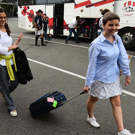 Warriors to Lourdes staff getting off shuttle bus with their luggage.