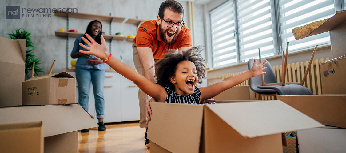 father pushing daughter in a moving box