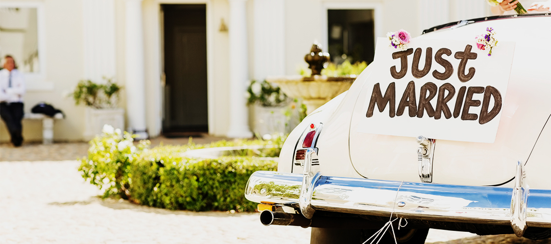 A car with a just married sign on it.
