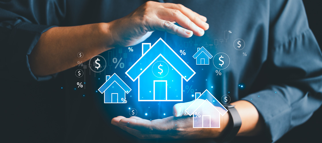 A person holding up a graphic of a home