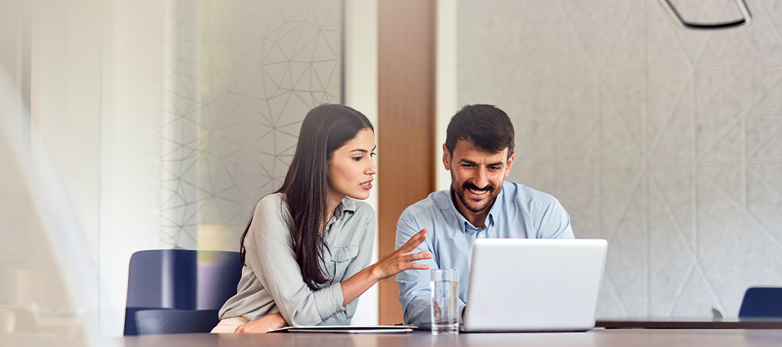 A couple looking a laptop together