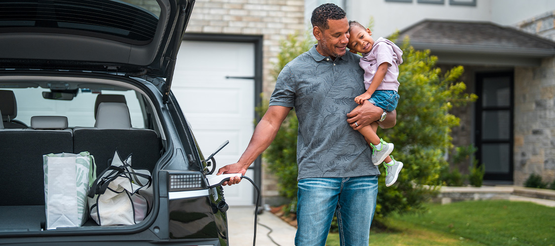 A family charging their electric car