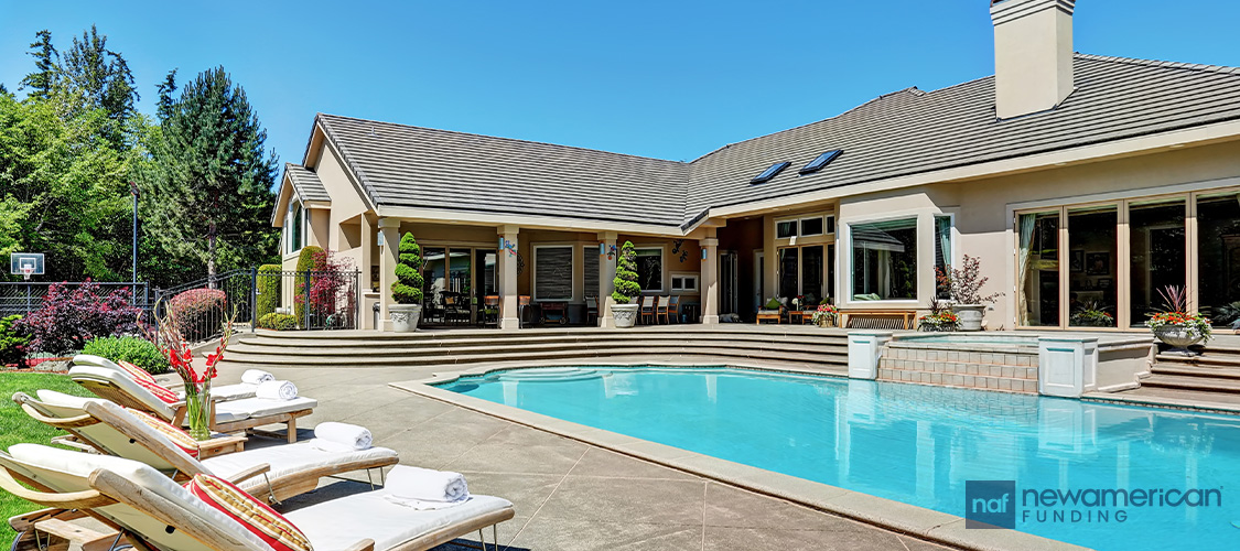 A home with an in-ground pool outside.