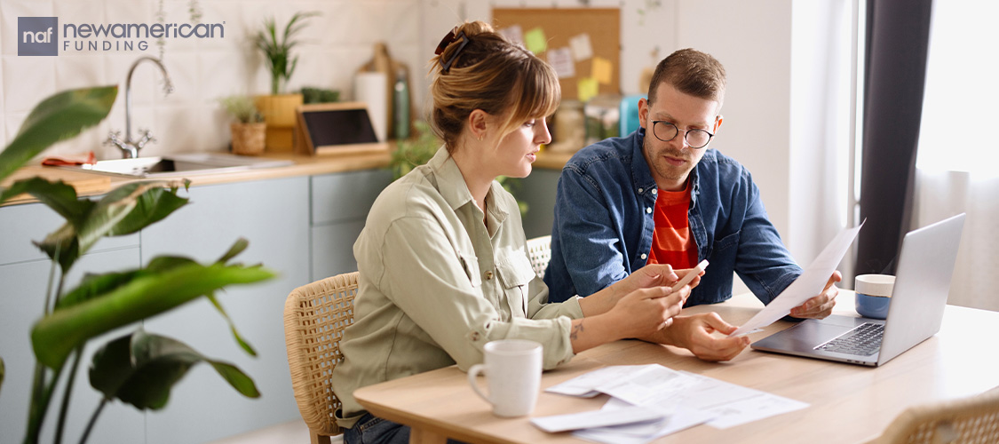 A couple going through paperwork together.