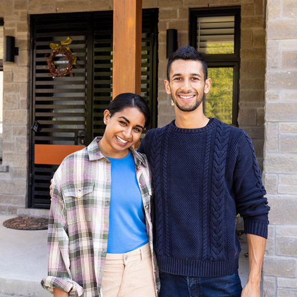 couple in front of their home