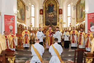 Bishop Stanislav Shyrokoradiuk celebrates the ordination Mass of Andrey Buchkovskyi (kneeling, left) and Konrad Szymański (kneeling, right) on May 27, 2023, in the Cathedral of the Assumption of the Blessed Virgin Mary in Odesa, Ukraine. (Photo courtesy of the Roman Catholic Church in Ukraine)