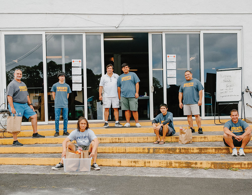 Volunteers with the Kupuna Needs Project, including Knights from several Oahu councils, gather May 2 to package and prepare deliveries for the elderly and vulnerable. Ryan Fielding (center, with his dad, John) started the delivery service with help from John and his brother Knights. Dallas Carter (far right) coordinated additional funding for the project from Knights in New Mexico.