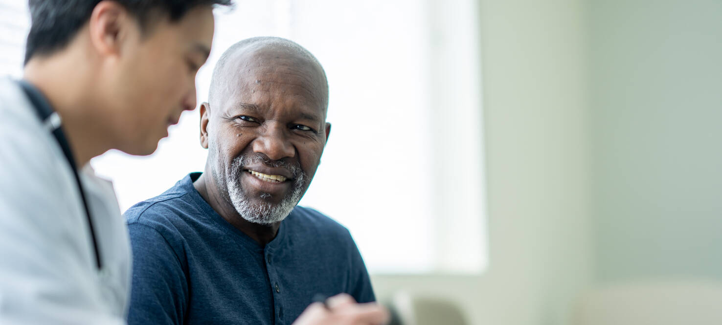 senior patient speaks with doctor
