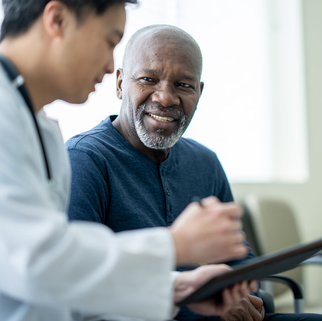 senior patient speaks with doctor