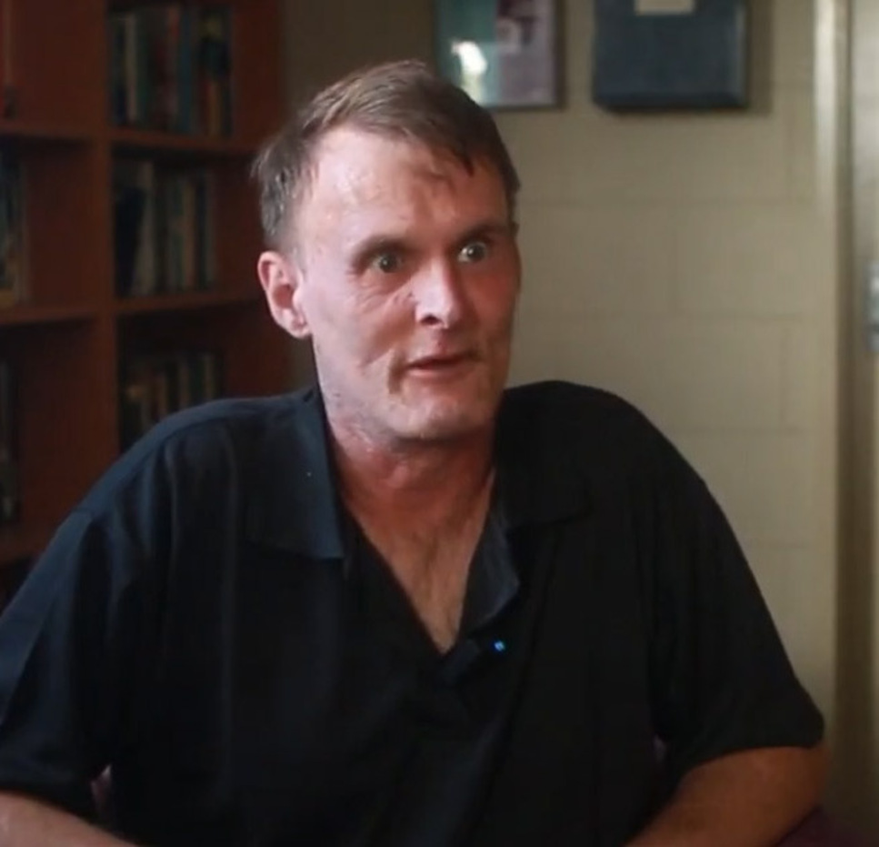 Ben sits in a chair while talking to camera about how Mission Australia helped him on his journey.