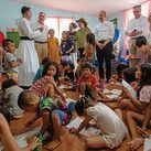 Father Matthieu Dauchez (in white cassock), director of the ANAK-Tulay Ng Kabataan Foundation, speaks to the K of C delegation during their visit to one of the foundation’s day care centers in the Aroma neighborhood of Tondo, Metro Manila, on Aug. 21.