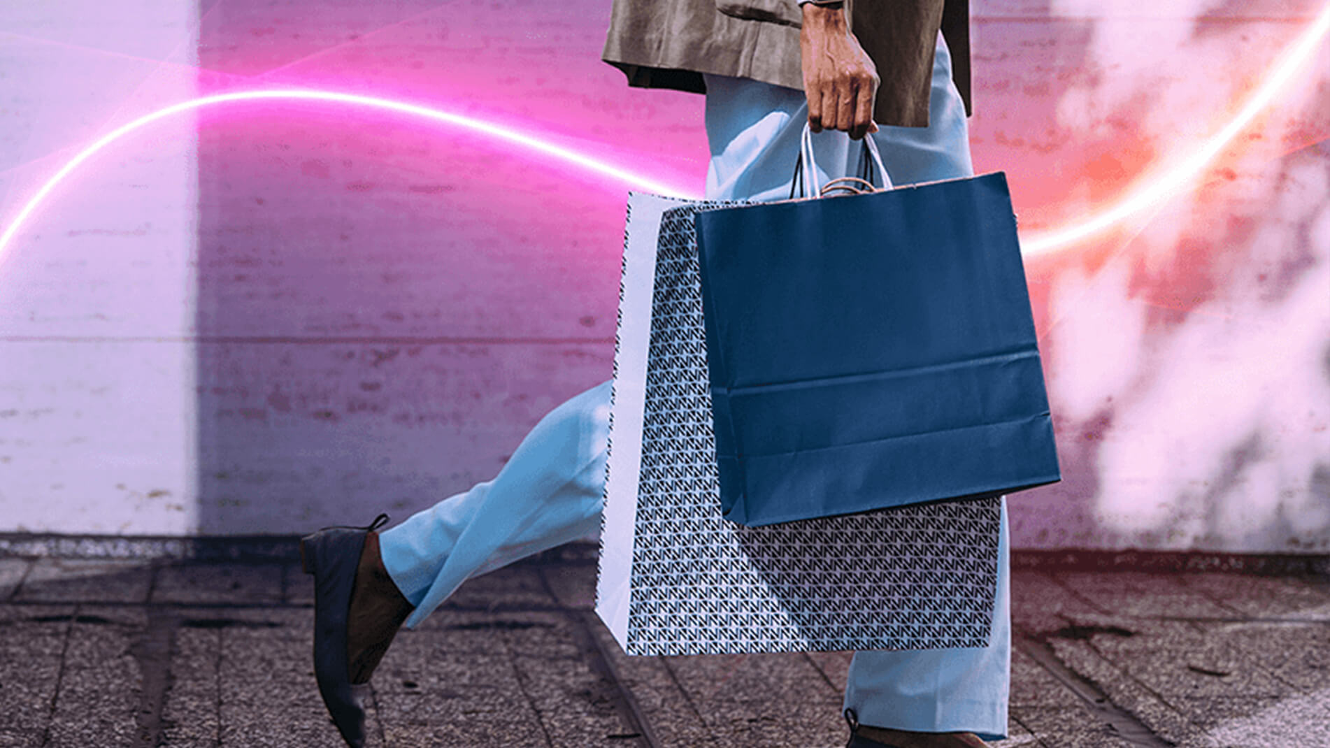 shopbags.jpg Profile image of a woman walking with shopping bags in her hand.