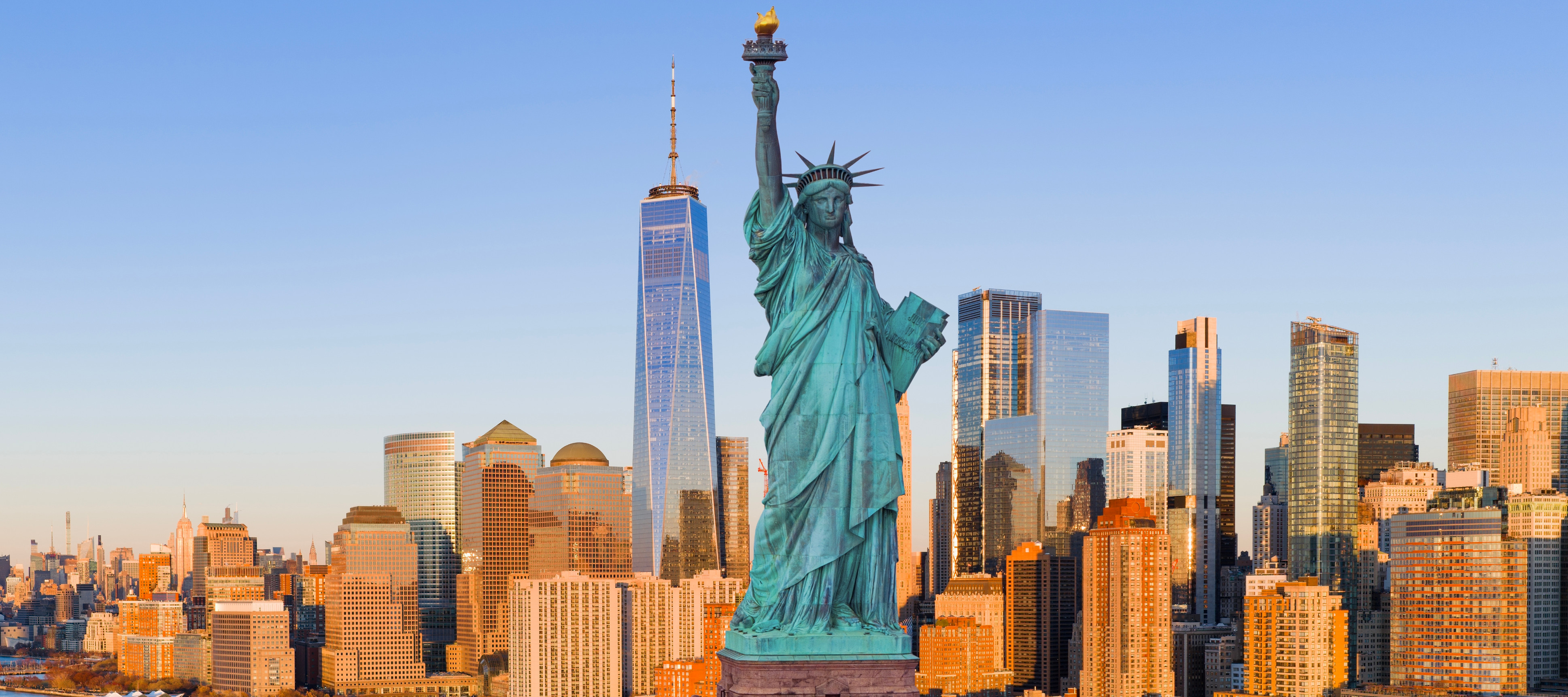 Statue of liberty with the manhattan city skyline in the background