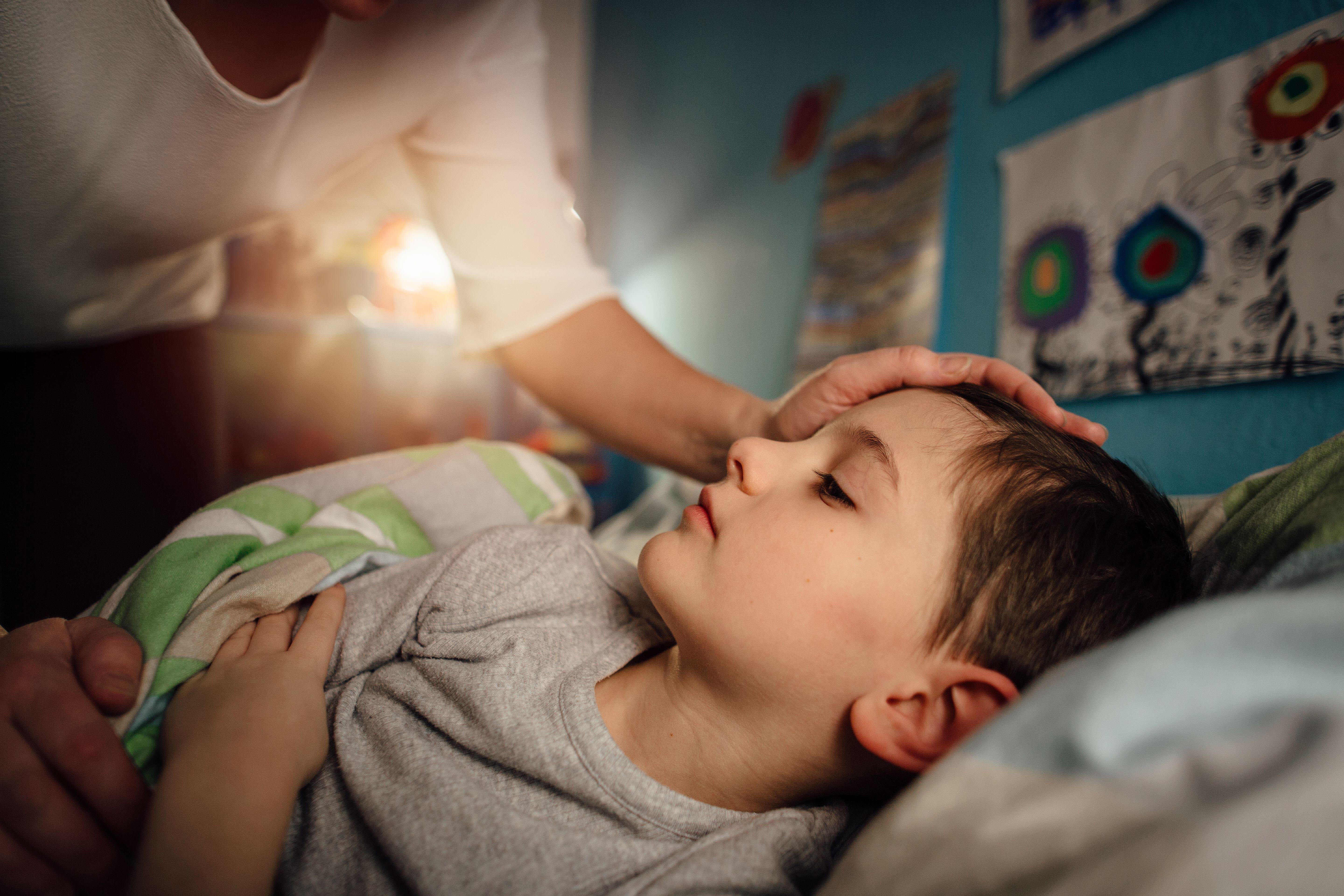 sick child being nursed by mother at night