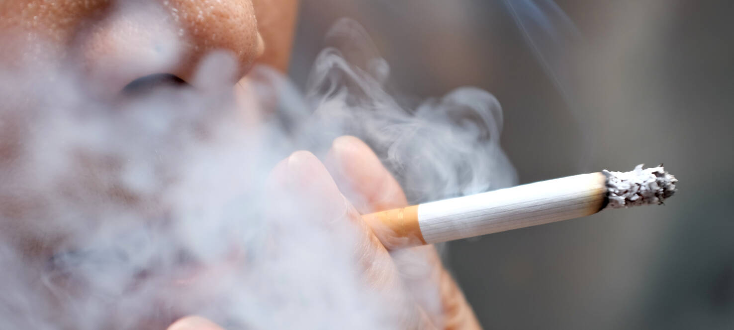 images of someone holding cigarette to their mouth