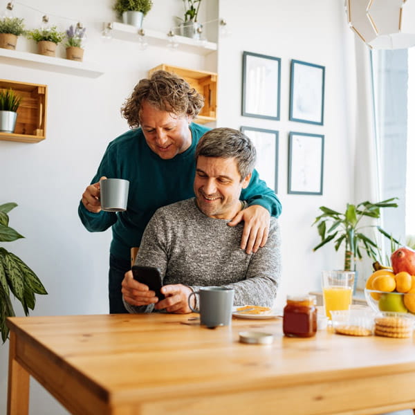 couple looking at a phone in the kitchen