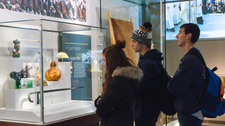 A group of students observing historical artifacts at the JP2 shrine.