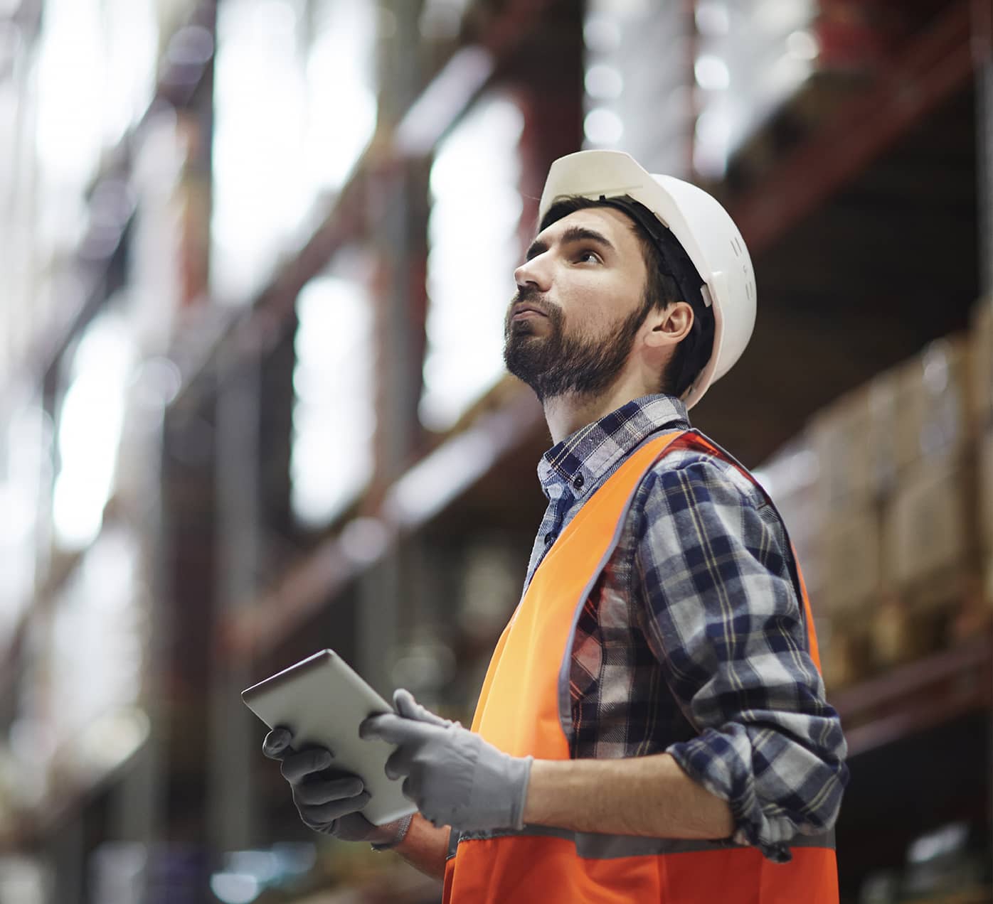 Warehouse worker using an iPad to look at inventory