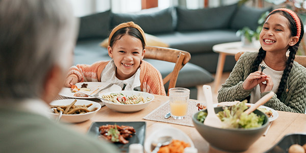 young girls eating with their grandpa