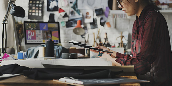 A person looks at samples of colored fabric