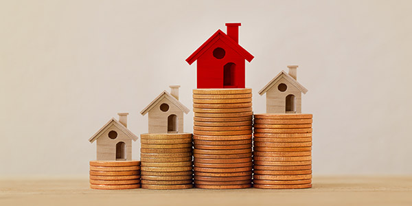 house models on stacks of coins