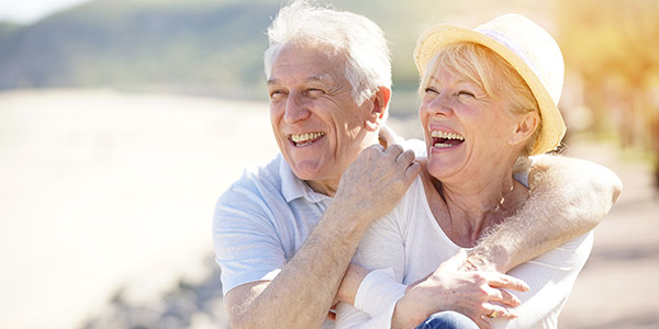 A senior white man and woman laugh together
