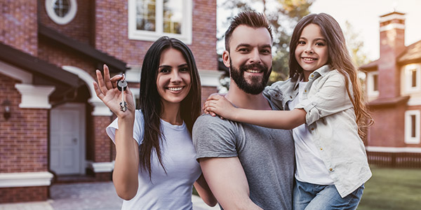 family showing off new house keys