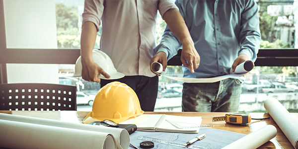 contractor plans and tools laid out on a table 