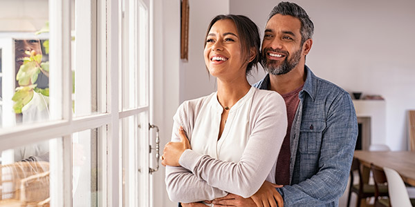 couple standing together by the window