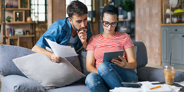 couple going over paperwork on the couch in the living room