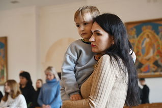 A woman holds her son during a Divine Liturgy in the chapel of the Ivano-Frankivsk Theological Seminary Dec. 30. The liturgy for families of fallen soldiers was organized by Holy Martyr Josaphat Council 18318. (Photo by Andrey Gorb)