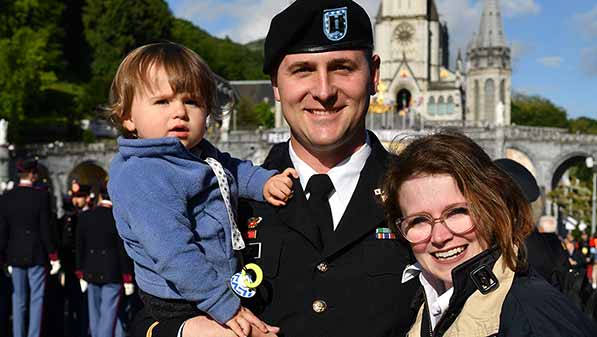 Army Captain Adam Fisk, Morgan Fisk, and their son Julian on the Warriors to Lourdes trip, 2019.