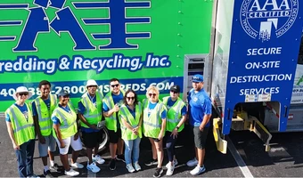 Group of workers in front of a shredding & recycling truck in Florida.